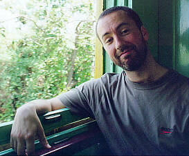 Paulo Tavares sitting by the window in an old steam train, between Anhumas and Jaguariuna, in Brazil.